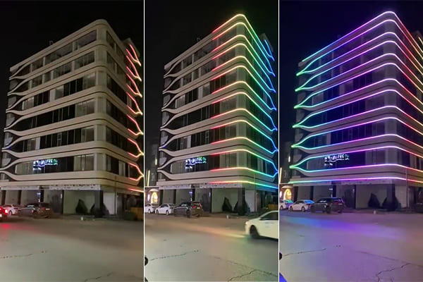 A building facade showing a dynamic color-changing light show